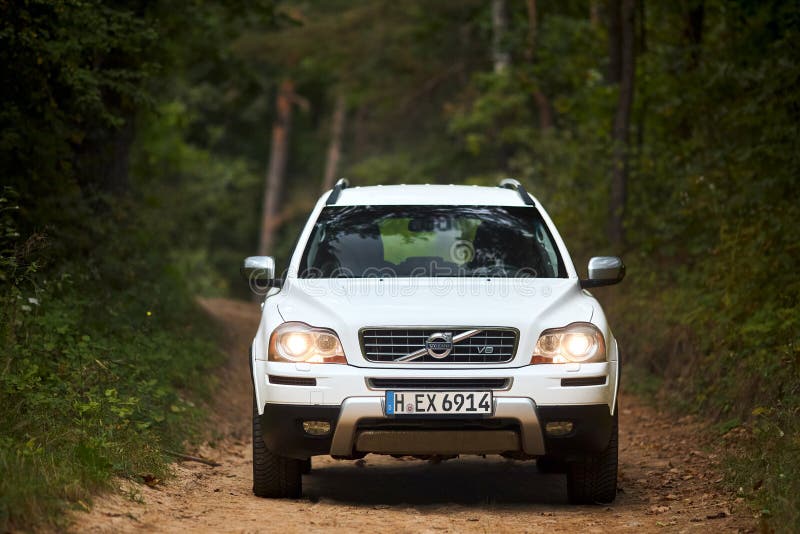 Berlin, Germany - October 3, 2023: Volvo XC90 4.4 v8 1st generation restyling 4WD SUV test drive in fall country road on forest background, front view. Berlin, Germany - October 3, 2023: Volvo XC90 4.4 v8 1st generation restyling 4WD SUV test drive in fall country road on forest background, front view