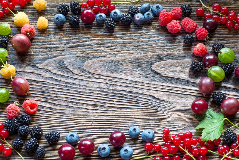 Berries on Wooden Background. Summer or Spring Organic Berry ove