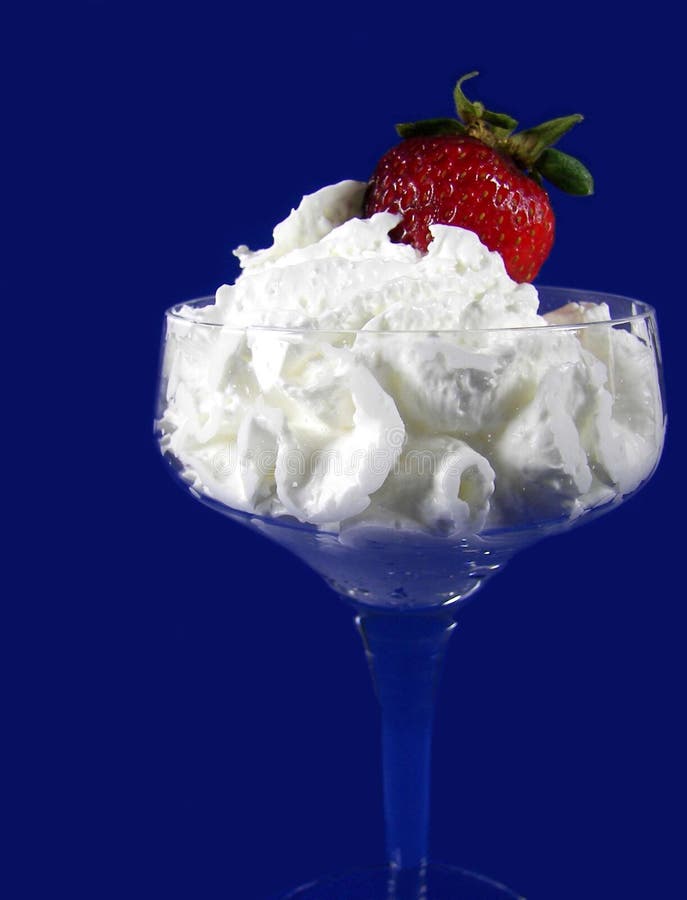 red strawberry in whipped cream