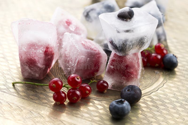 Berry fruits frozen in ice cubes