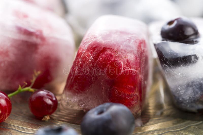 Berry fruits frozen in ice cubes