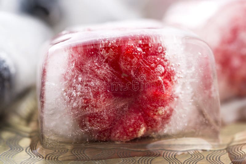 Berry fruits frozen in ice cubes