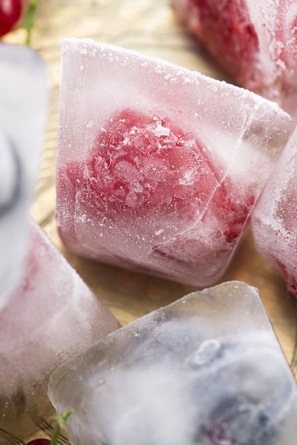 Berry fruits frozen in ice cubes