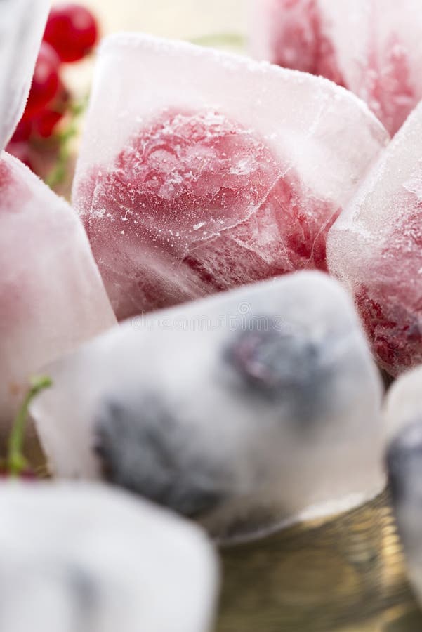 Berry fruits frozen in ice cubes