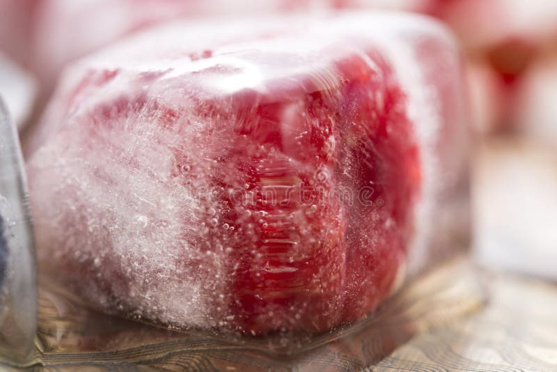 Berry fruits frozen in ice cubes