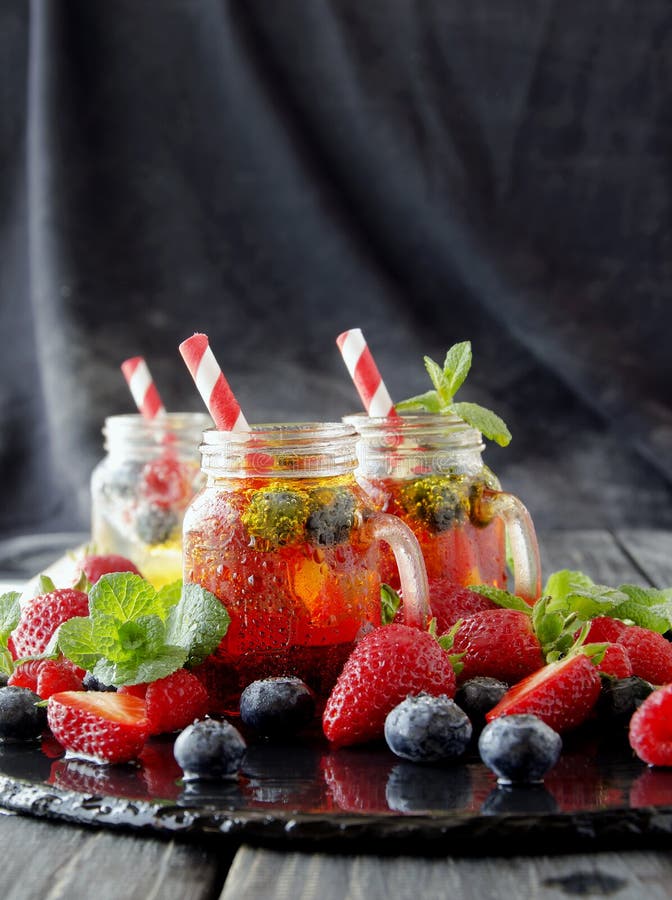 Berry Juice in a Glass with Berries, Ice and Mint Stock Photo Image