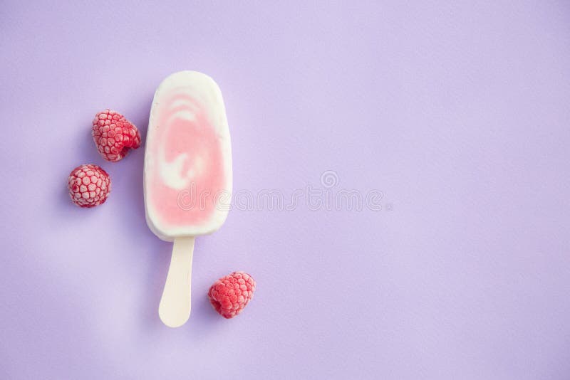 Berry sorbet and yogurt popsicle with raspberry on a lilac background. Berry sorbet and yogurt popsicle with raspberry on a lilac background