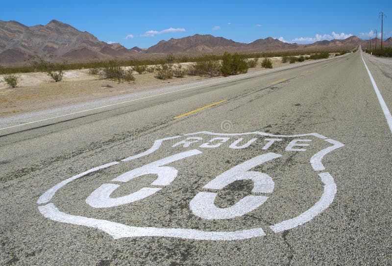 Long road with a Route 66 sign painted on it. Long road with a Route 66 sign painted on it