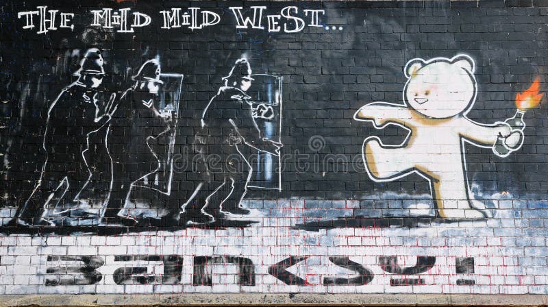 BRISTOL - SEPTEMBER 26: Famous Banksy piece titled Mild Mild West on a brick wall in the city centre on September 26, 2010 in Bristol, UK. Bristol is internationally known for its graffiti and street art. BRISTOL - SEPTEMBER 26: Famous Banksy piece titled Mild Mild West on a brick wall in the city centre on September 26, 2010 in Bristol, UK. Bristol is internationally known for its graffiti and street art.