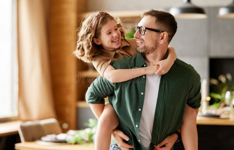 Young Joyful Father and Daughter Playing Together at Home Stock Photo