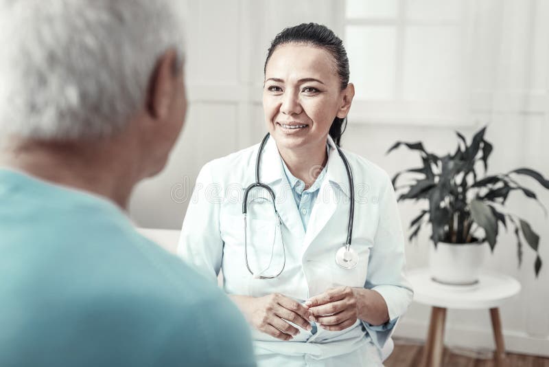 Skilled cute nurse smiling and having consultation.