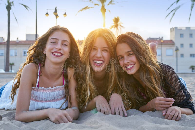 Best friends girls at sunset beach sand