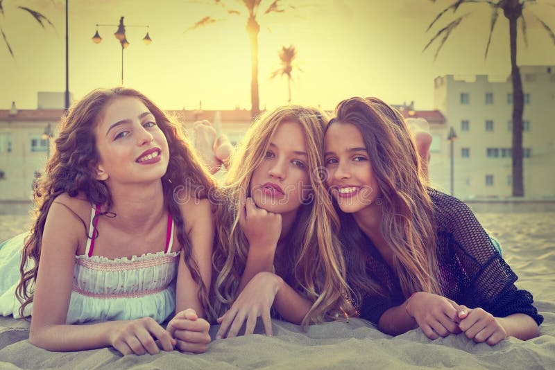 Best friends girls at sunset beach sand