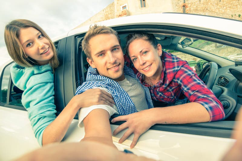 Best friends having fun together at car trip on the road