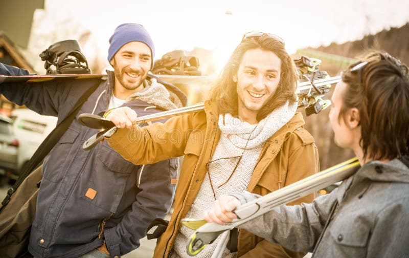 Best friends having fun together walking with ski and snowboard stock image Best friends having fun together walking with ski and snowboard stock image