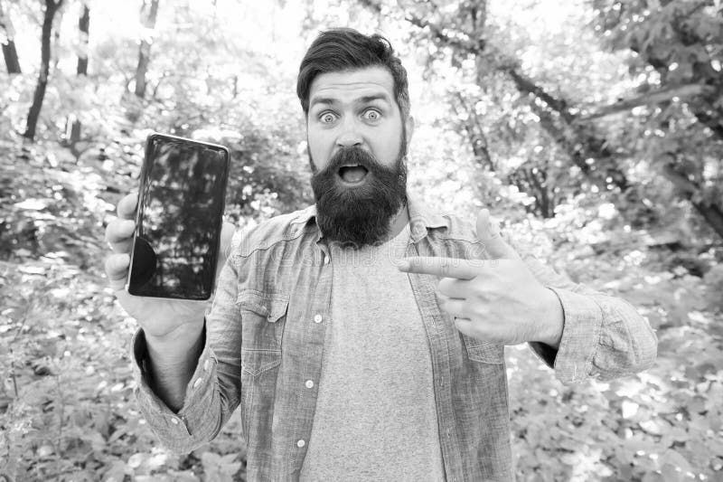Best GPS and navigation apps. Man bearded wanderer walking in forest with navigation application. Useful software for royalty free stock photography