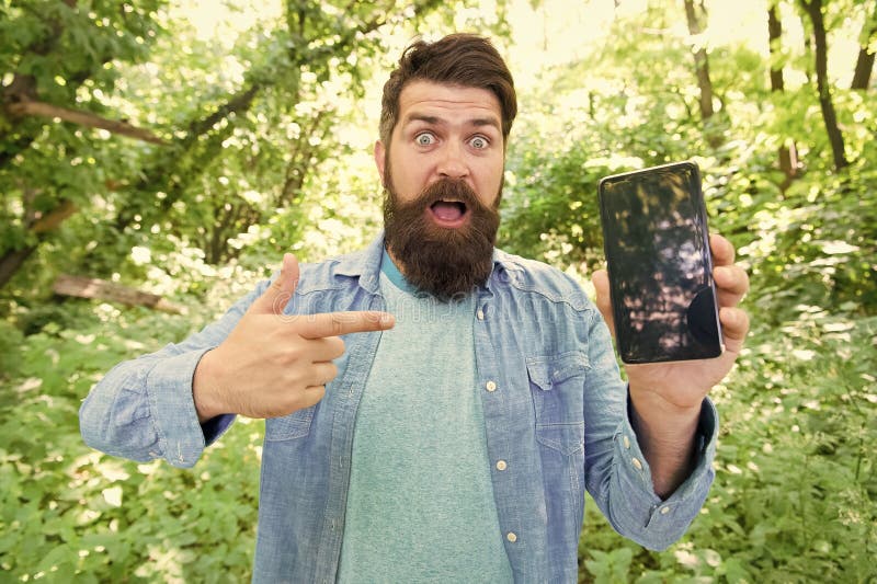 Best GPS and navigation apps. Man bearded wanderer walking in forest with navigation application. Useful software for stock photography