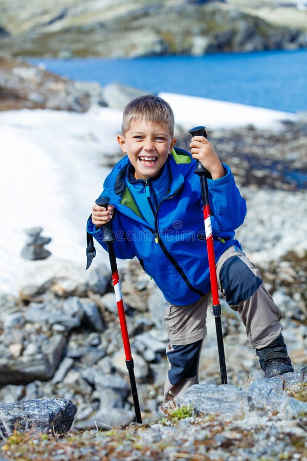 Best Norway hike. Cute girl with hiking equipment in the mountains