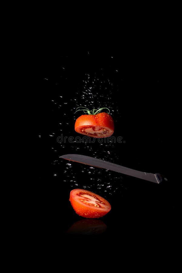 Best red tomato cut in half on black background