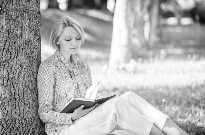 Best self help books for women. Books every girl should read. Girl concentrated sit park lean tree trunk read book stock images Best self help books for women. Books every girl should read. Girl concentrated sit park lean tree trunk read book stock images