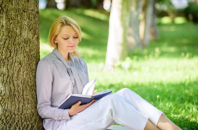 Best self help books for women. Books every girl should read. Girl concentrated sit park lean tree trunk read book