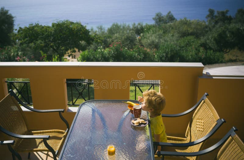Best summer day. Breakfast on the terrace. Apartments near the sea. Greek morning. Food for children. royalty free stock photo Best summer day. Breakfast on the terrace. Apartments near the sea. Greek morning. Food for children. royalty free stock photo