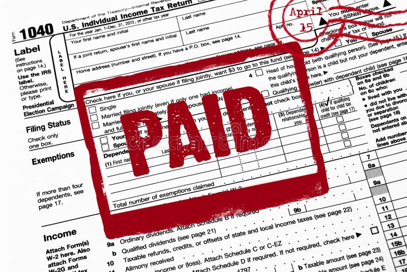 Bold red paid stamp on an income tax form. Bold red paid stamp on an income tax form.