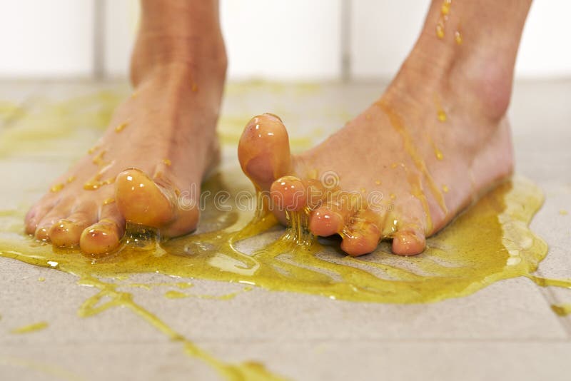 Young woman playing with melted Jelly in white tile room. Young woman playing with melted Jelly in white tile room