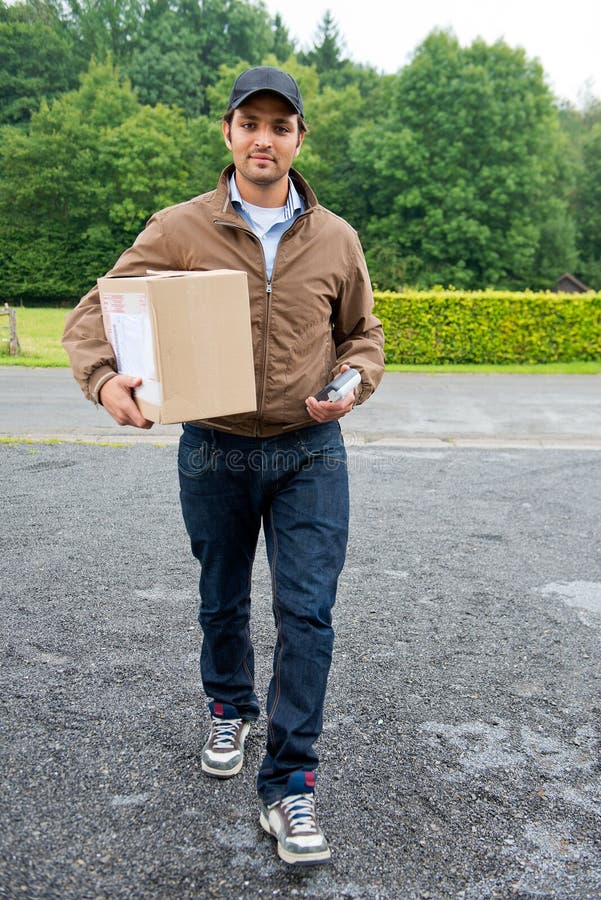 Delivery guy bringing a cash on delivery parcel with online purchases to the door, with a wireless cash machine in his hand. Delivery guy bringing a cash on delivery parcel with online purchases to the door, with a wireless cash machine in his hand