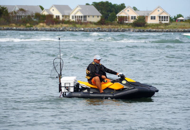 Bethany Beach, Delaware, U.S - August 22, 2020 - A man on the jet ski fishing for flounder near Indian River Inlet in the summer