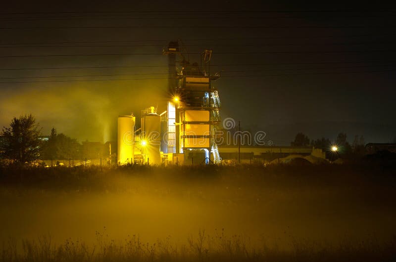 Mix plant for concrete and asphalt by night with fog in front of it. Mix plant for concrete and asphalt by night with fog in front of it.