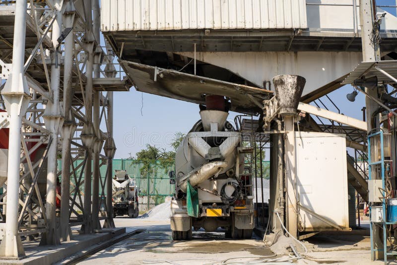 Mixer concrete trucks waiting to load concrete mixing at batching factory for go to the casting place on building site. Mixer concrete trucks waiting to load concrete mixing at batching factory for go to the casting place on building site.