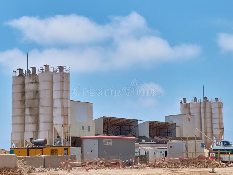 Concrete batching plant silos on the construction site. Concrete batching plant silos on the construction site.