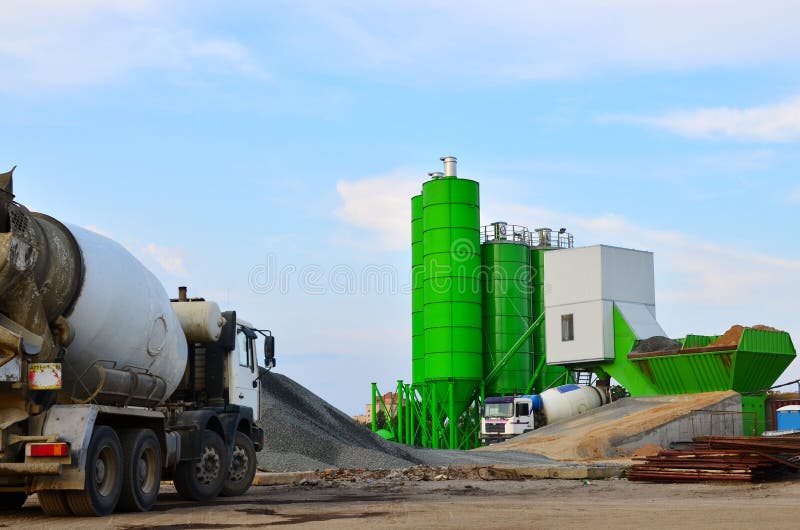 Concrete batching plant. Industrial producing concrete for construction. Heavy mixer concrete trucks waiting for to be loaded on the concrete factory - Image. Concrete batching plant. Industrial producing concrete for construction. Heavy mixer concrete trucks waiting for to be loaded on the concrete factory - Image