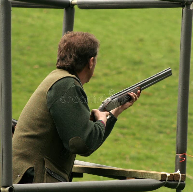 Clay pigeon shooter waits for his targey. Clay pigeon shooter waits for his targey