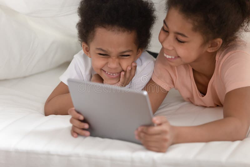 Bettelnde Schwester und Bruder mit Tablet-Computer stockfotos