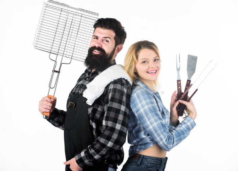 A better grill for a better cook. Happy hipster and sexi girl holding picnic set for barbecue. Family couple having picnic party. women and bearded men enjoying picnic or cookout. Family picnic.