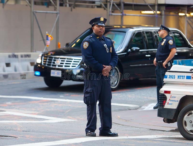 New York, United States - September 21 2009 : a vip diplomatic cars passes over an intersection blocked off by a policeman. New York, United States - September 21 2009 : a vip diplomatic cars passes over an intersection blocked off by a policeman