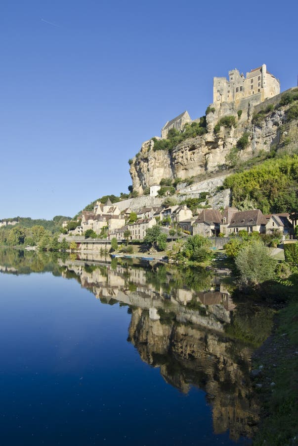 A tranquil scene at the Dordogne River at Beynac in the Aquitaine area of France on a cold late September morning. Medieval Beynac Village is said to be one of the most scenic villages in France. In the Middle Ages the area was the border between French and English territories. A tranquil scene at the Dordogne River at Beynac in the Aquitaine area of France on a cold late September morning. Medieval Beynac Village is said to be one of the most scenic villages in France. In the Middle Ages the area was the border between French and English territories.