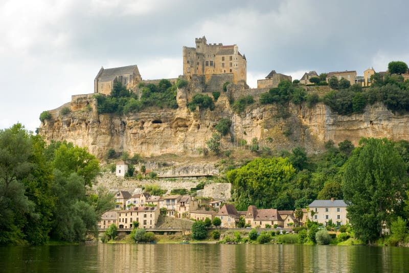 The france city of Beynac-et-Cazenac as seen from the river Dordogne. The france city of Beynac-et-Cazenac as seen from the river Dordogne