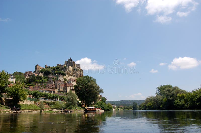 The Chateau de Beynac towering over the town of Beynac on the banks of the Dordogne river, France. The Chateau de Beynac towering over the town of Beynac on the banks of the Dordogne river, France