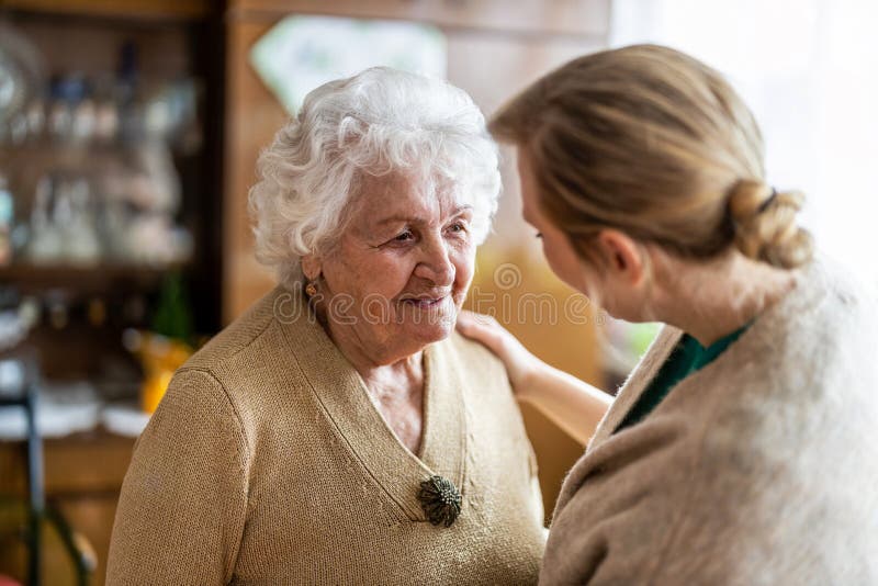 Friendly nurse supporting an elderly lady. Friendly nurse supporting an elderly lady