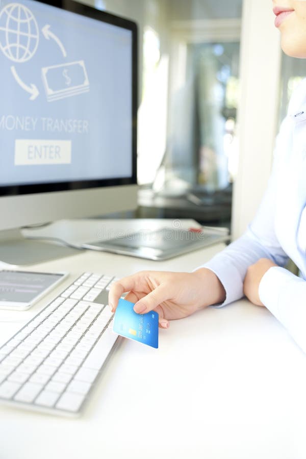 Shot of a businesswoman hand while holding bank card and making online payments by credit card. Shot of a businesswoman hand while holding bank card and making online payments by credit card.