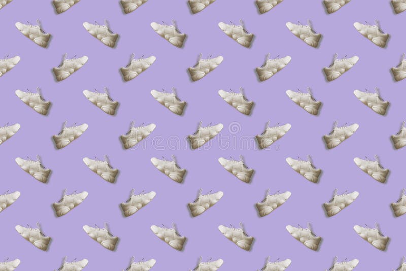 Seamless regular pattern women`s casual sneakers on a lilac background. Photo collage. Fashion blog, sport lifestyle. Printing on fabric, wrapping paper. Seamless regular pattern women`s casual sneakers on a lilac background. Photo collage. Fashion blog, sport lifestyle. Printing on fabric, wrapping paper