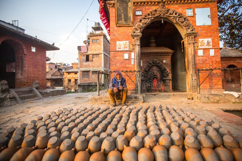 BHAKTAPUR, NEPAL - Nepalese man working in his pottery workshop. stock image