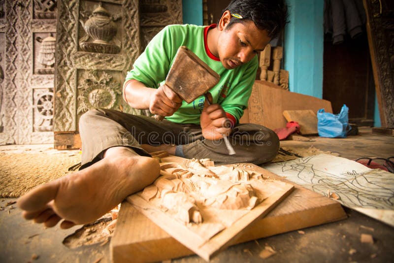 BHAKTAPUR, NEPAL - Unidentified Nepalese man working in the his wood workshop. royalty free stock images