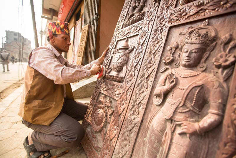 BHAKTAPUR, NEPAL - Unidentified Nepalese man working in the his wood workshop. stock image