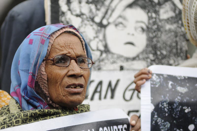 BHOPAL- DECEMBER 2: An old woman in front of the most iconic image of Bhopal Disaster during the rally to mark the 26th year of the Bhopal Gas Disaster, in Bhopal - India on December 2, 2010. BHOPAL- DECEMBER 2: An old woman in front of the most iconic image of Bhopal Disaster during the rally to mark the 26th year of the Bhopal Gas Disaster, in Bhopal - India on December 2, 2010.