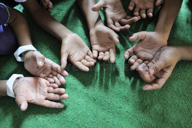 BHOPAL- NOVEMBER 15: 3rd Generation victims of Bhopal gas disaster symbolically asking for help during a regular school session in a free clinic in Bhopal - India on November 15, 2010.