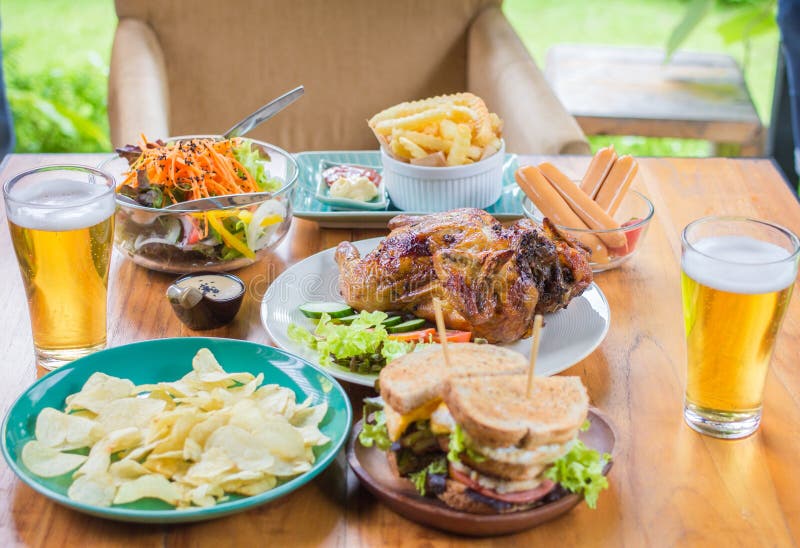 Beer Dining Concept,With Chicken roasting,salad,French fries on wooden table. Beer Dining Concept,With Chicken roasting,salad,French fries on wooden table